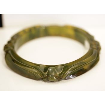 Art Deco Bakelite bangle with translucent olive and butterscotch marbling and floral carvings.