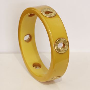 Vintage Butterscotch Bakelite bangle with gold hollow metal heart inserts.