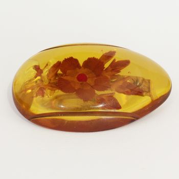 Art Deco transluscent Amber Bakelite brooch, with embedded flowers, C1930's.