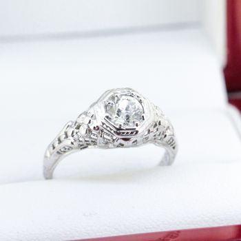 An Art Deco Diamond Ring in 18k White Gold featuring a stunning center Diamond weighing a total of approximately 0.55 carat.