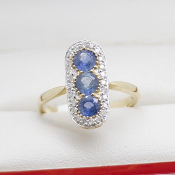 sapphire diamond pill ring, 9ct yellow gold, pill-shaped design, natural blue sapphires, sparkling diamonds, elegant jewelry, fine craftsmanship, polished finish, extended shoulders, open back.