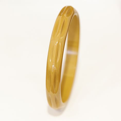Art Deco era carved butterscotch Bakelite bangle.