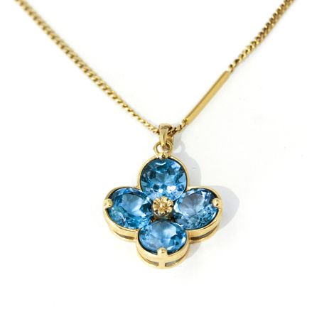 Vintage blue Topaz  flower shaped pendant on a yellow gold chain, Beautiful.