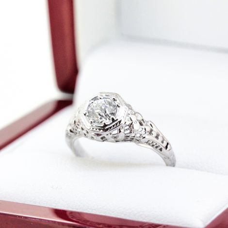 An Art Deco Diamond Ring in 18k White Gold featuring a stunning center Diamond weighing a total of approximately 0.55 carat.