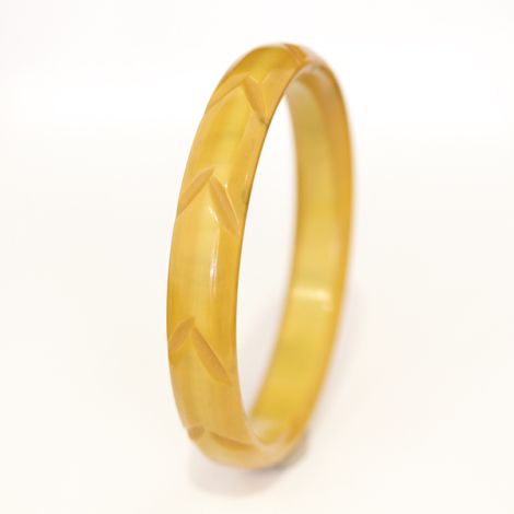 Deco era lightly carved butterscotch Bakelite bangles.