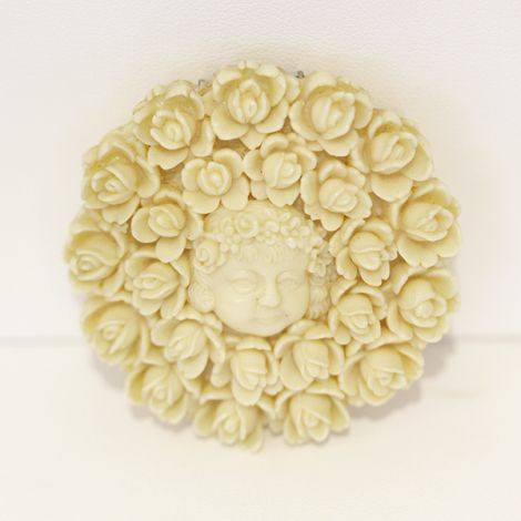Beautiful Deco Ivory coloured round Celluloid dress clip with childs face and floral design