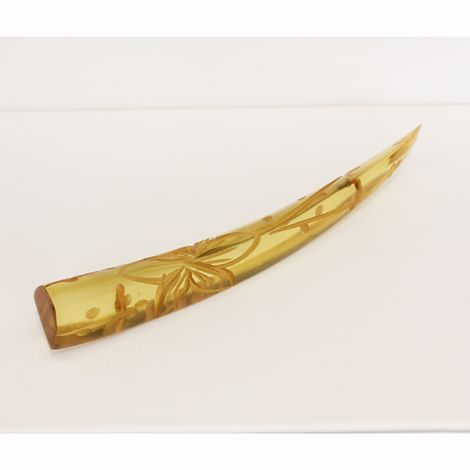 Vintage Art Deco transluscent Tusk shaped Bakelite brooch, with floral carving.